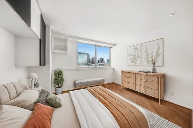 a bedroom with furniture and painting on the wall