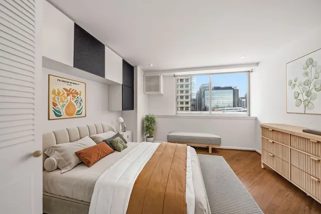 a bedroom with a bed and a couch