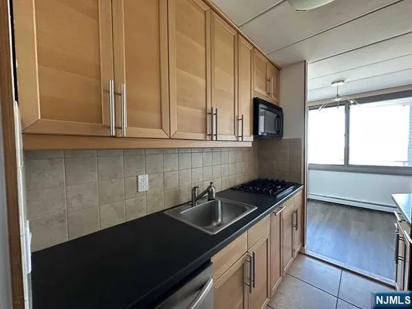 a kitchen with granite countertop a sink and a stove