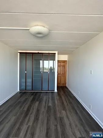 a view of a room with wooden floor