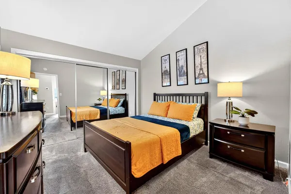 a bedroom with a bed and a couch