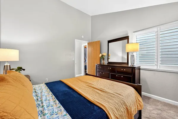 a bedroom with a bed and a dresser