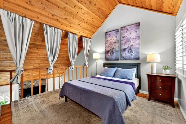 a bedroom with a bed next to a window