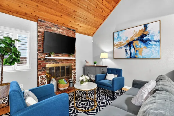 a view of a livingroom with furniture and a flat screen tv