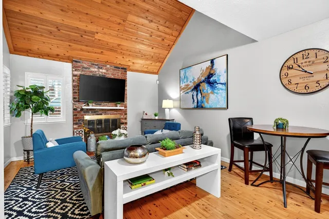 a living room with furniture a rug and a flat screen tv
