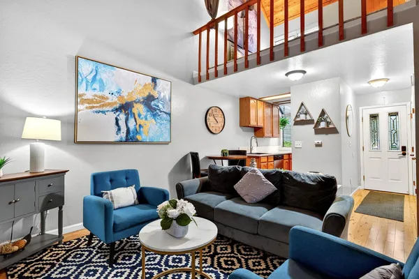 a living room with furniture and kitchen view