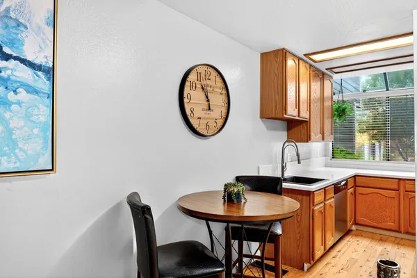 a dining room with furniture and a large window