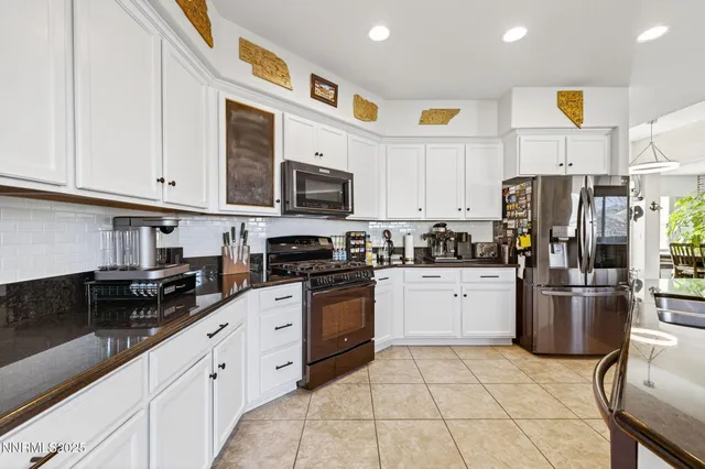 a bedroom with a bed and a flat tv screen on dresser