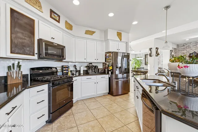 a bathroom with a granite countertop sink a large mirror and a shower