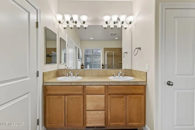 an aerial view of a city with lots of residential buildings ocean and mountain view in back