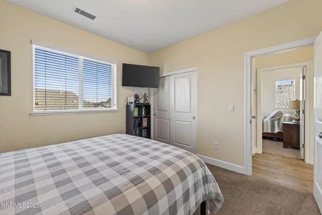 a view of a chairs and table in the back yard of the house
