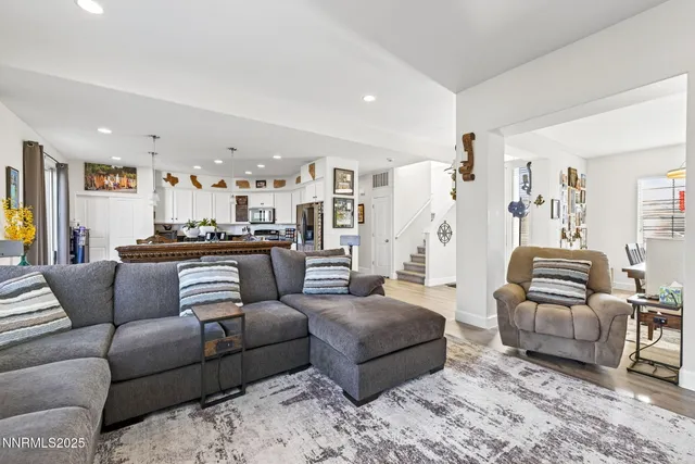 a spacious bedroom with a bed and wooden floor