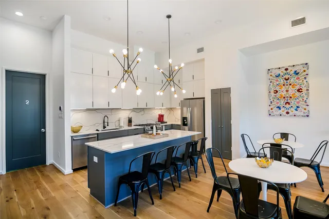 a kitchen that has a table and chairs in it