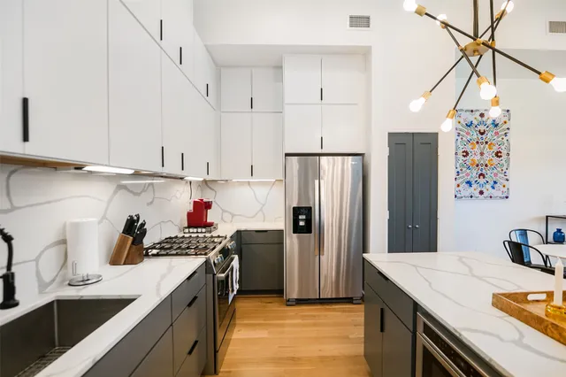 a kitchen with refrigerator and cabinets