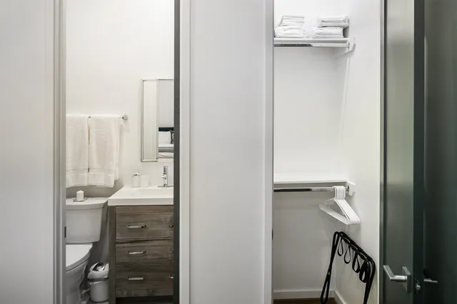 a bathroom with a double vanity sink a mirror and a bathtub