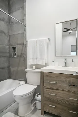 a bathroom with a sink a toilet and bathtub