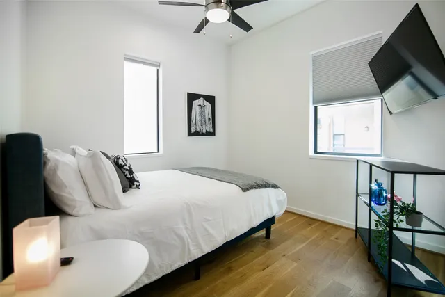 a bedroom with a bed and flat screen tv