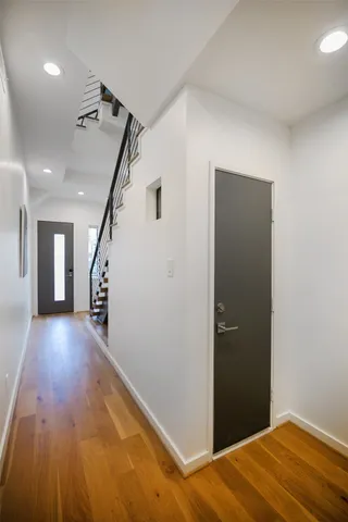 a view of a hallway with wooden floor