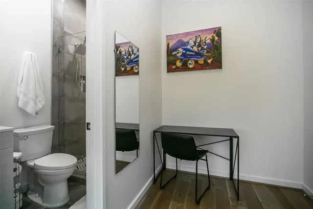 a bathroom with a toilet and a shower