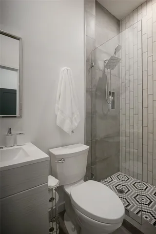 a white toilet sitting next to a bathroom sink