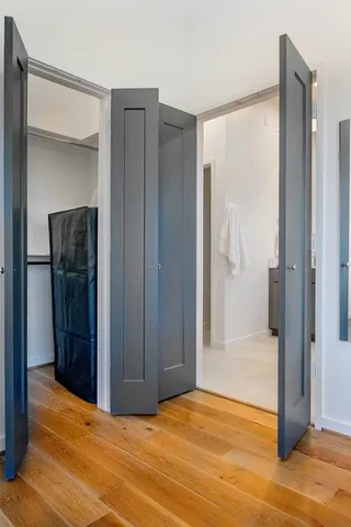 a view of empty room with wooden floor and cabinet