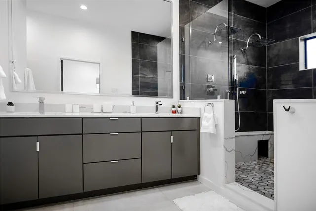 a bathroom with a sink vanity and a mirror
