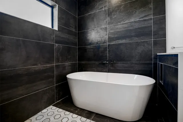 a white bath tub sitting in a bathroom