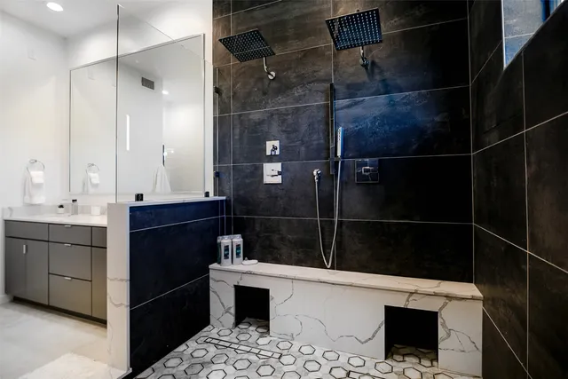 a bathroom with a sink a toilet and shower