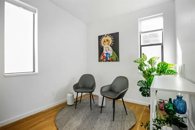 a workspace room with furniture and a potted plant