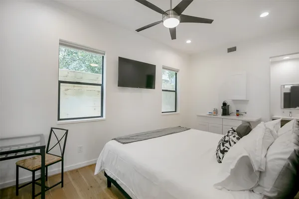 a bedroom with a large bed and a tv