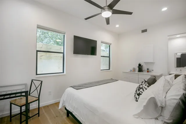 a bedroom with a large bed and a tv