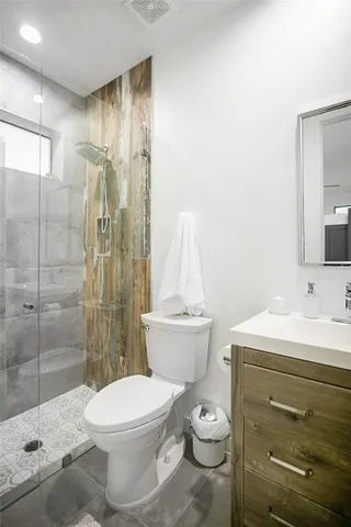 a bathroom with a sink toilet and shower