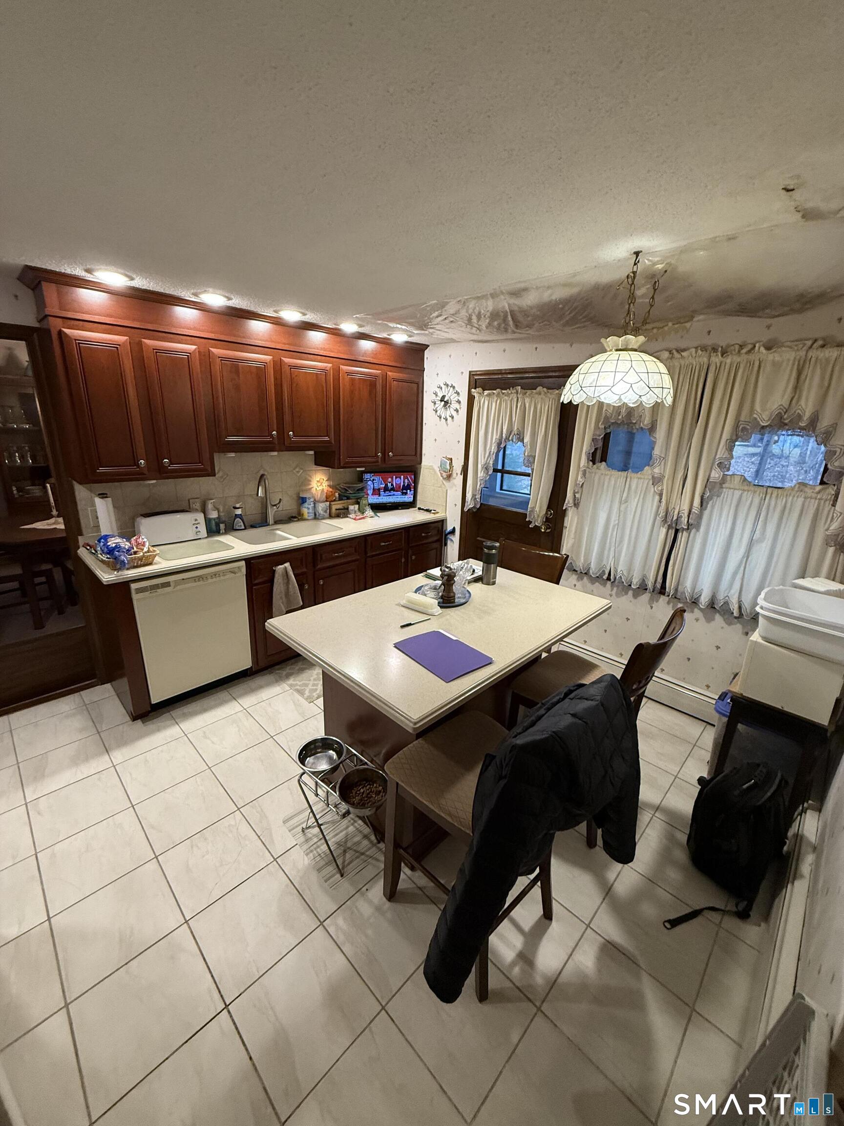149 High Tower Road Southington, CT 06489 - Photo 11 of 25 a kitchen with a sink a stove and chairs