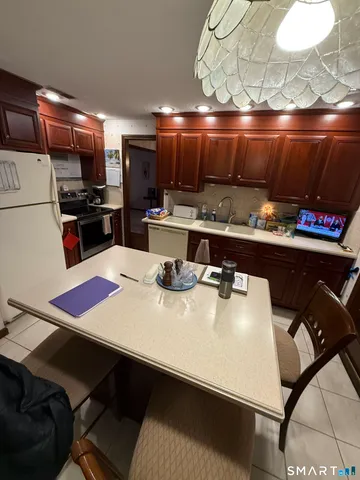 a kitchen with a table chairs and a appliances