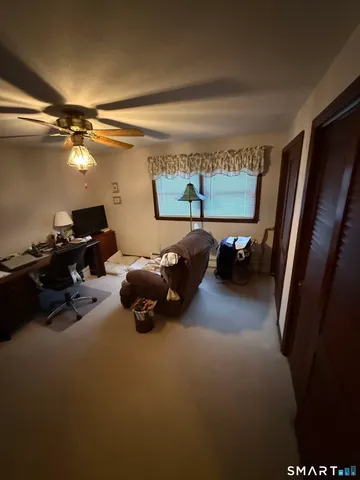 a bed room with furniture and a flat screen tv