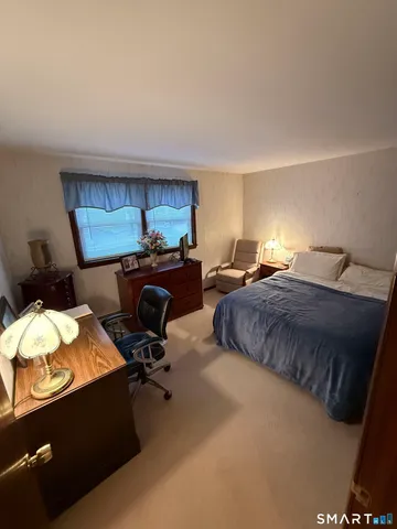 a bedroom with a bed and a desk
