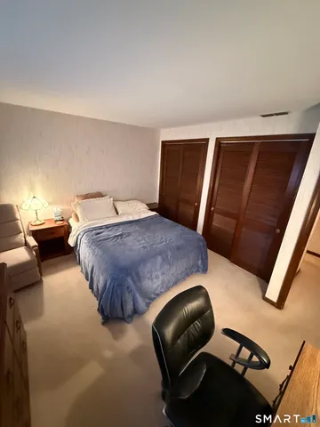 a bedroom with furniture and wooden floor