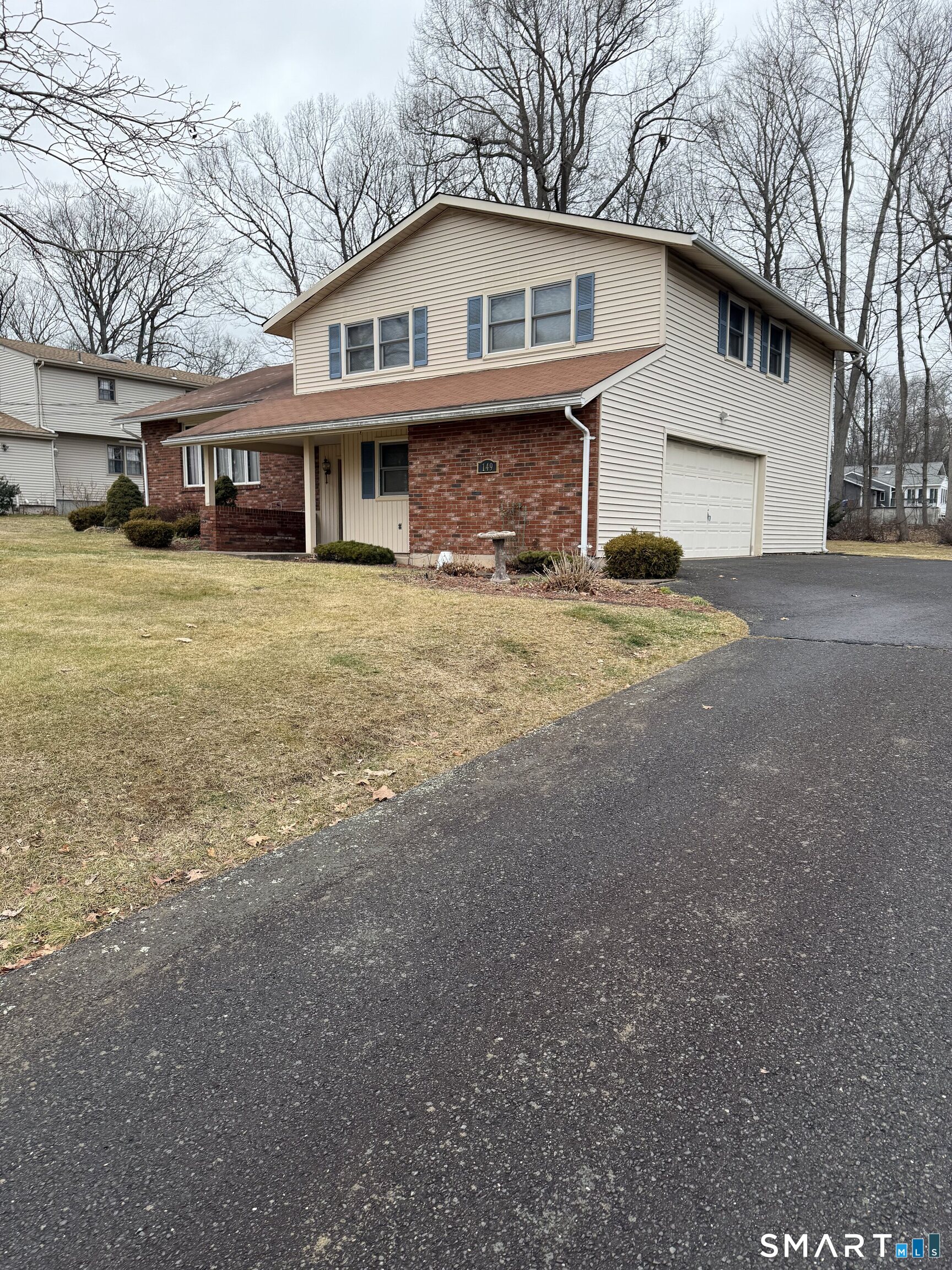 149 High Tower Road Southington, CT 06489 - Photo 3 of 25 a front view of a house with a yard and garage