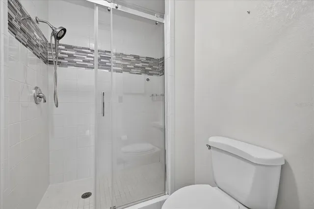 a bathroom with a shower and toilet