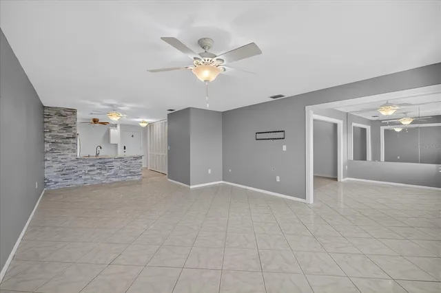 a view of a livingroom with a ceiling fan and window