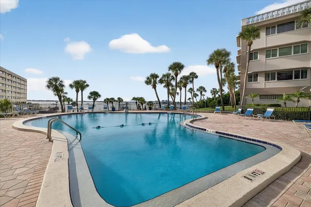 a view of a swimming pool with outdoor seating