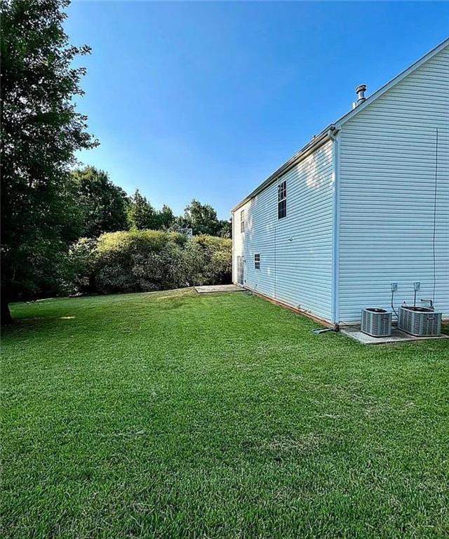 3267 Forrest Bluff Way Lithonia, GA 30038 - Photo 14 of 15 a backyard of a house with plants and large tree