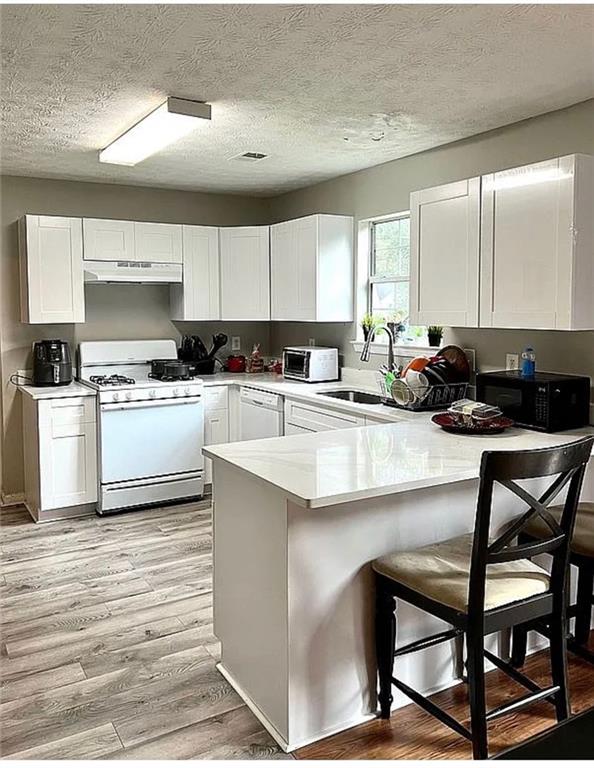 3267 Forrest Bluff Way Lithonia, GA 30038 - Photo 2 of 15 a kitchen with a table chairs stove and cabinets