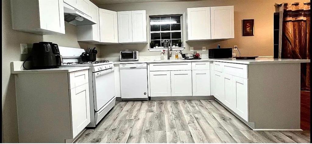 3267 Forrest Bluff Way Lithonia, GA 30038 - Photo 3 of 15 a kitchen with cabinets appliances a sink and a counter top space