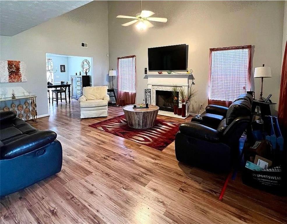 3267 Forrest Bluff Way Lithonia, GA 30038 - Photo 6 of 15 a living room with furniture a flat screen tv and a fireplace