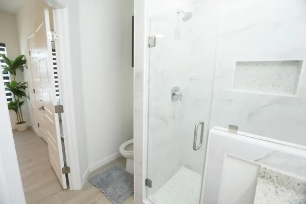 a bathroom with a shower and toilet