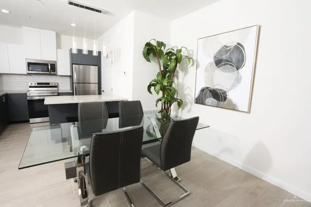 a dining room with furniture and a potted plant