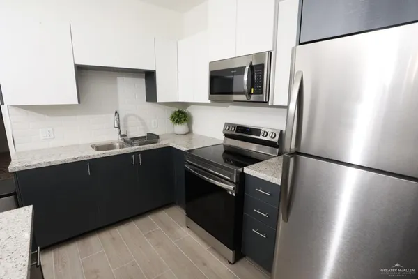 a kitchen with a refrigerator sink and microwave