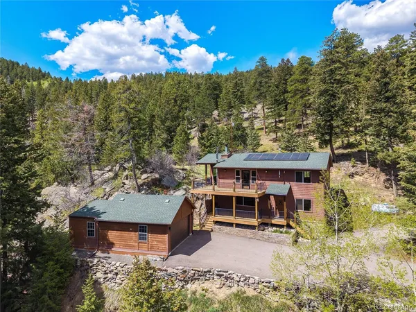 an aerial view of a house with a yard