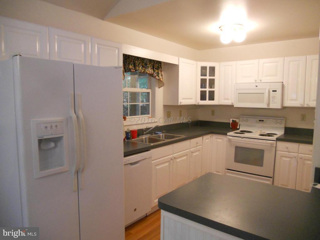 21 Rabbit Run Lane Ocean Pines, MD 21811 - Photo 2 of 22 a kitchen with stainless steel appliances a refrigerator sink and stove